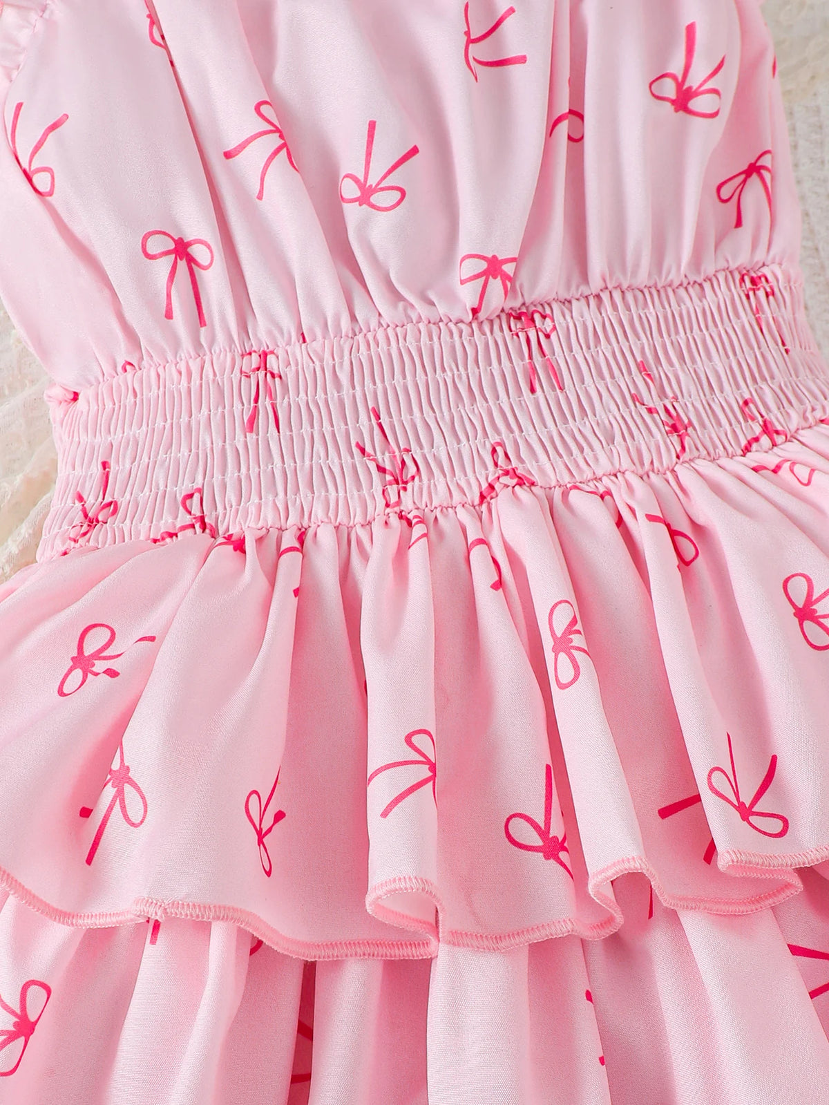 Robe fille rose à motif nœud papillon – CLEVI Paris